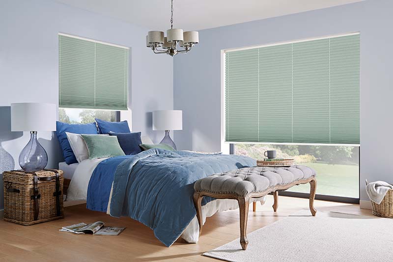 pleated blinds in bedroom in soft mineral green colour