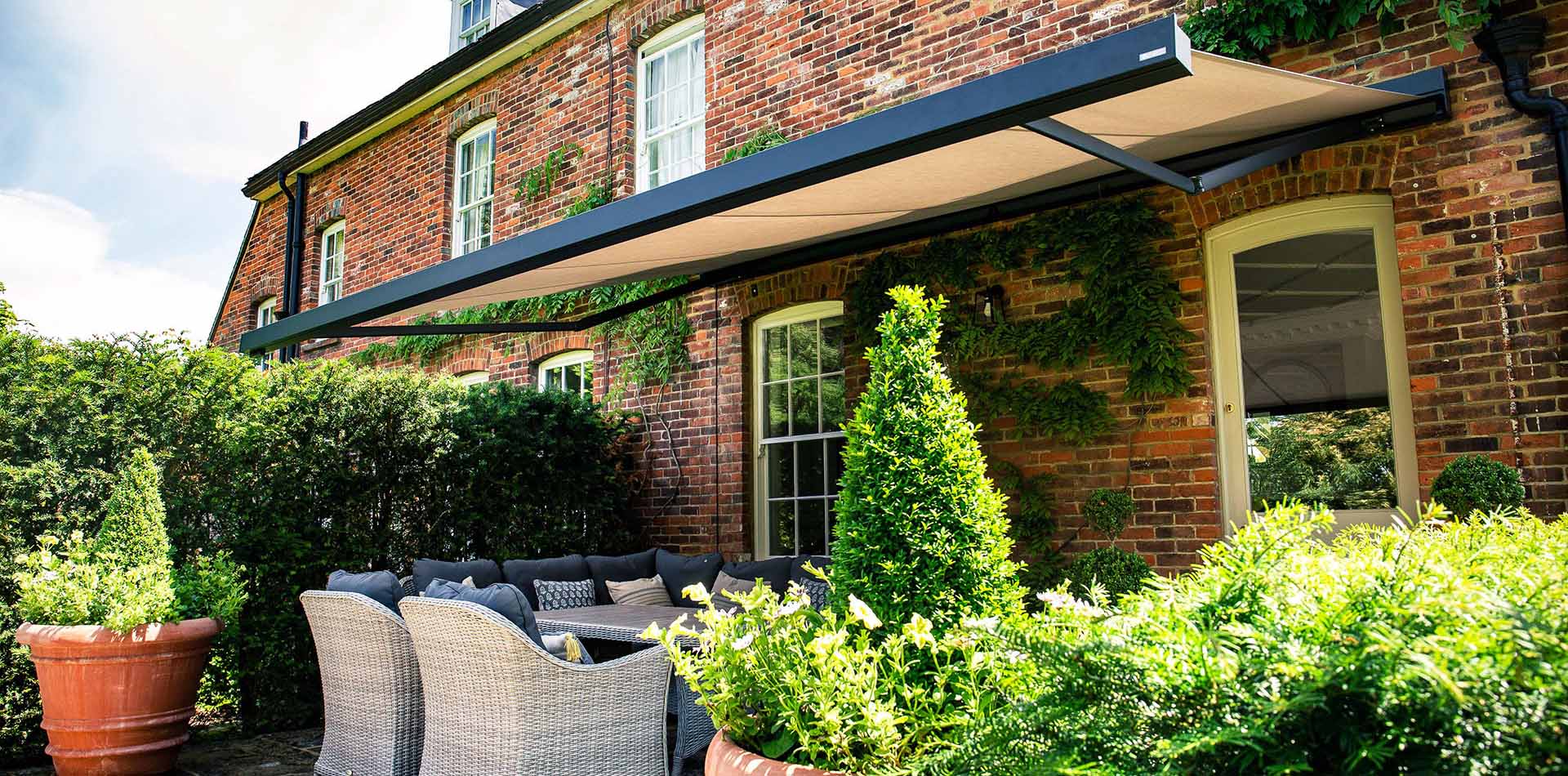 caribbean blinds patio awning over outside seating area on period cottage in dorset