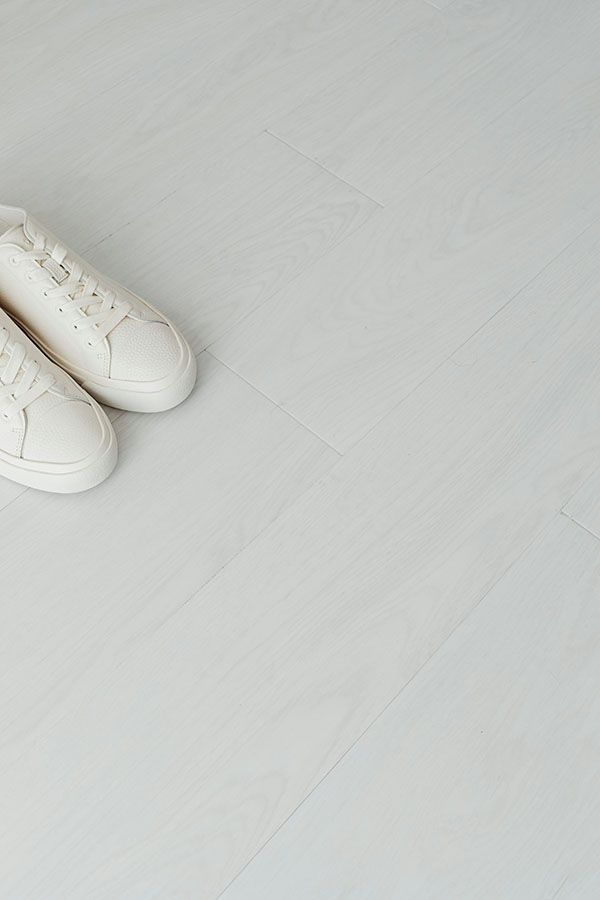 light coloured vinyl flooring with pair of shoes
